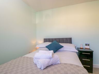 A bedroom with a bed and nightstand at Swallows Nest in Bourton-On-The-Water