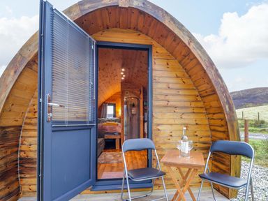 An entrance with chairs and a table at The Pod at Greenbank in Isle of Skye