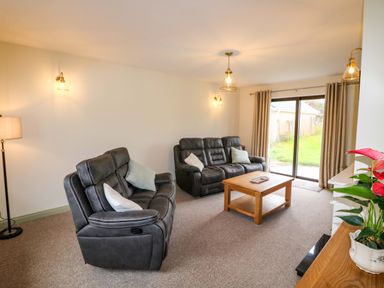 A living room with reclining chairs and a coffee table at Shamrock House