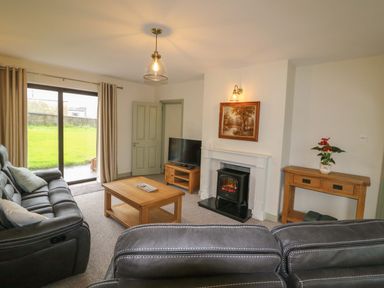 A living room with a sofa and coffee table at Shamrock House