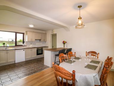 A kitchen with a dining area and appliances at Shamrock House