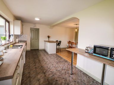 A kitchen with counter, stove and sink at Shamrock House