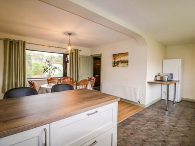 A kitchen with a dining table and chairs at Shamrock House