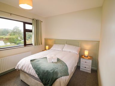 A bedroom with bed and window at Shamrock House