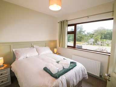 A bedroom with a bed and window at Shamrock House