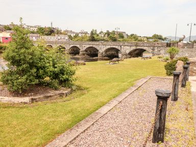 A park with a stone bridge and benches at Shamrock House, Killorglin, County Kerry