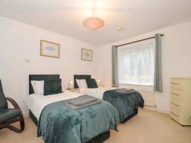 A bedroom with two beds and a dresser at Upper Court Cottage, Broad Langdon near Wainhouse Corner