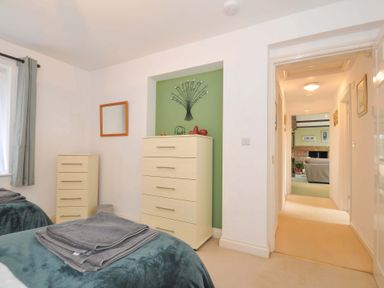 A bedroom with beds and storage furniture at Upper Court Cottage Broad Langdon near Wainhouse Corner