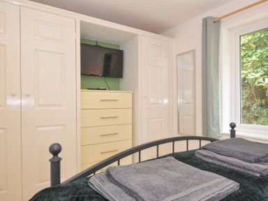 A bedroom with a bed and storage furniture at Upper Court Cottage Broad Langdon near Wainhouse Corner