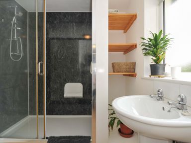 A bathroom with a shower, toilet, and sink at Upper Court Cottage in Broad Langdon near Wainhouse Corner