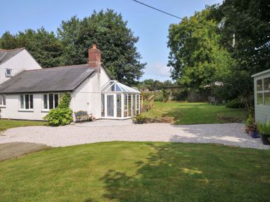 A house with a conservatory and garden at Upper Court Cottage Broad Langdon near Wainhouse Corner