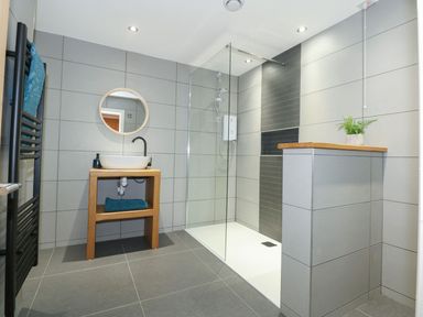 A bathroom with a shower and basin at Criw in Bryncroes near Sarn Meyllteyrn