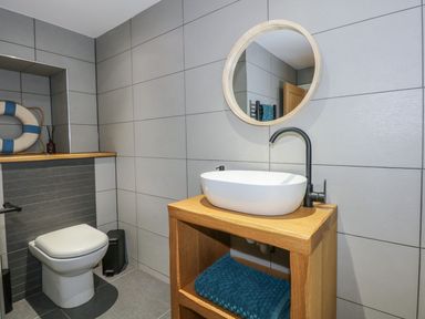 A bathroom with a sink and a toilet at Criw in Bryncroes near Sarn Meyllteyrn
