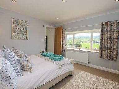 A bedroom with a bed and window view at Criw in Bryncroes near Sarn Meyllteyrn