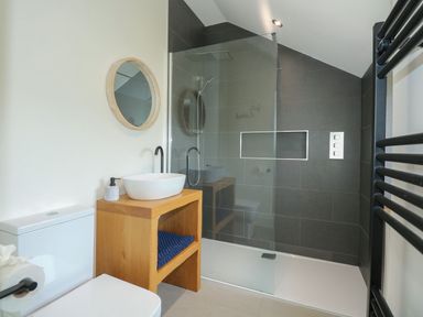 A bathroom featuring a shower, sink, and toilet at Criw, Bryncroes near Sarn Meyllteyrn