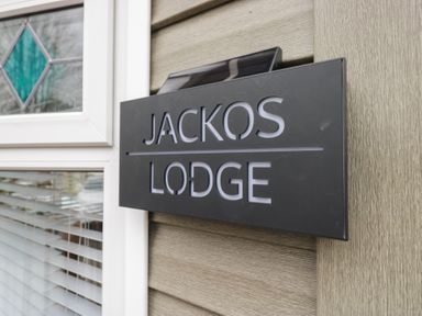 A sign displaying 'JACKOS LODGE' next to a window