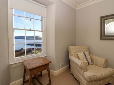 A sitting room with a view of the sea at Zenobia in New Quay