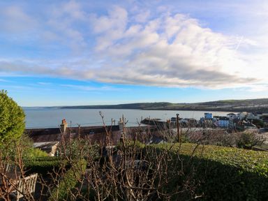 A view of the ocean and houses at Zenobia in New Quay