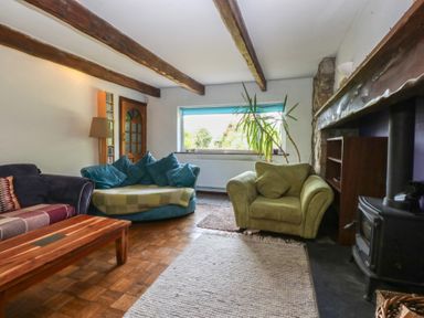 A living room with a sofa and a coffee table at Neuadd Wen in Gaerwen