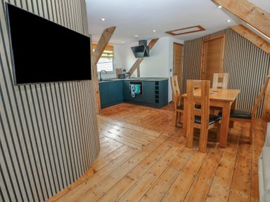 A kitchen with a dining area at Awel Deg, Tresaith
