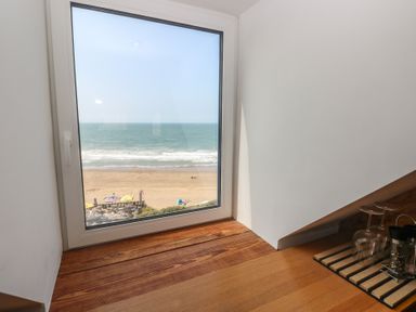 A view of the beach and ocean from a room at Awel Deg, Tresaith
