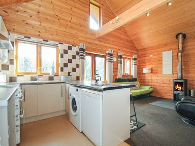 A kitchen with appliances and seating at Trevano in St Breward