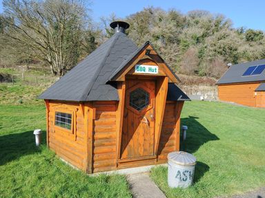 A BBQ hut with a chimney in a garden at Trevano in St Breward