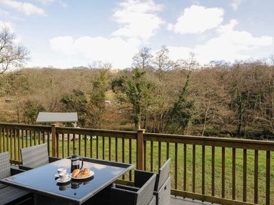 An outdoor seating area with a table and chairs at Pencarrow St Breward