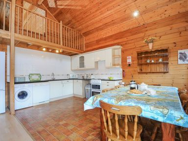 A kitchen with appliances and a table at Pencarrow in St Breward
