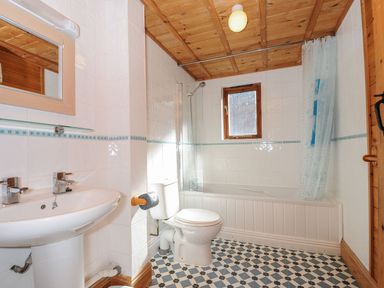 A bathroom with a sink, toilet, bathtub, and shower at Pencarrow in St Breward