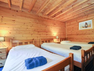 A bedroom with two beds and a nightstand at Eden in St Breward