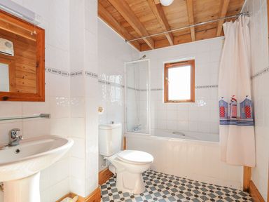 A bathroom with a sink, toilet, shower, and bathtub at Eden in St Breward