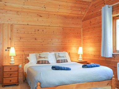 A bedroom with a bed and wooden features at Eden in St Breward