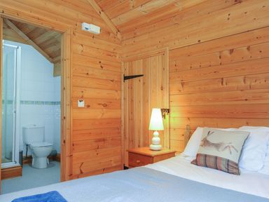 A bedroom with a bed and bathroom access at Eden in St Breward