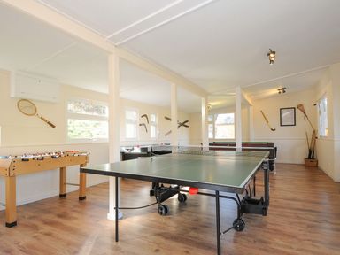A games room with a table tennis table and foosball table at Eden in St Breward