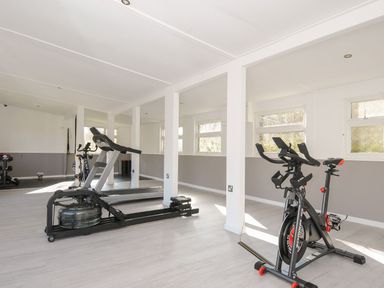 A gym with exercise equipment including a treadmill and bike at Eden St Breward