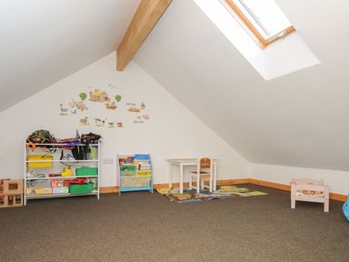 A playroom with a table and chair at Heligan in St Breward