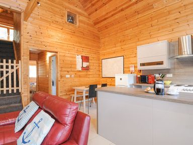 A kitchen with appliances and seating at Polzeath in St Breward