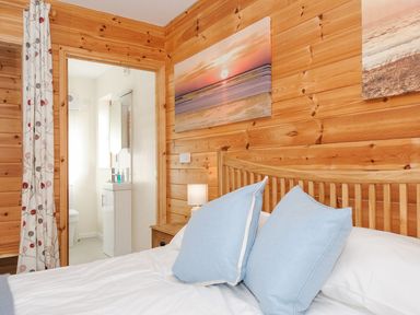 A bedroom with a bed and attached bathroom at Polzeath in St Breward