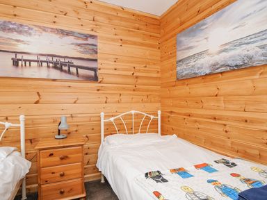 A bedroom with two beds and wall art at Polzeath in St Breward