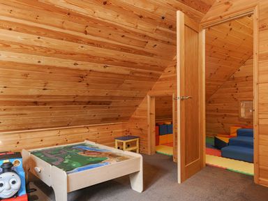 A children's room with a play table and toy train at Polzeath in St Breward