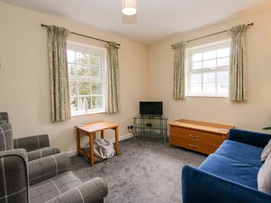 A living room with a sofa and coffee table at Buckbarrow in Seascale