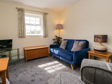 A living room with a sofa and television at Buckbarrow in Seascale