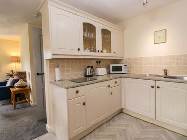 A kitchen with cabinets and appliances at Buckbarrow in Seascale