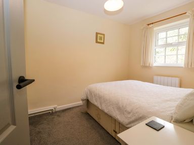 A bedroom with a bed and window at Buckbarrow in Seascale