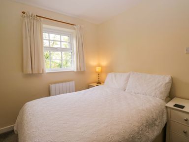 A bedroom with a bed and nightstand at Buckbarrow in Seascale