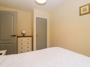 A bedroom with a bed and a drawer at Buckbarrow Seascale