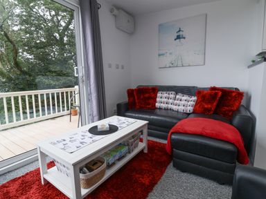 A living room with a sofa and coffee table at I C Lundy Too Bideford Bay Holiday Park near Woolfardisworthy