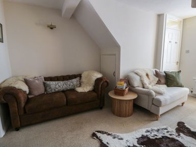 A living room with two couches and a coffee table at Cariad Cottage in Hereford