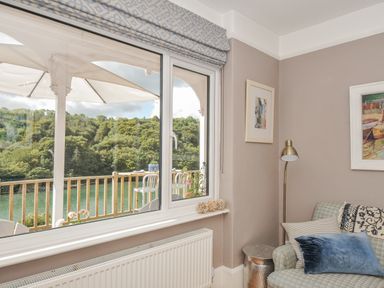 A living room with a view of the river at Mayhurst in Looe